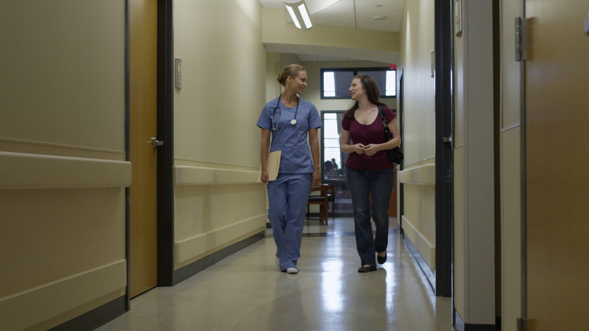 LandingPage-MA_Patient & MA walking down hallway 1